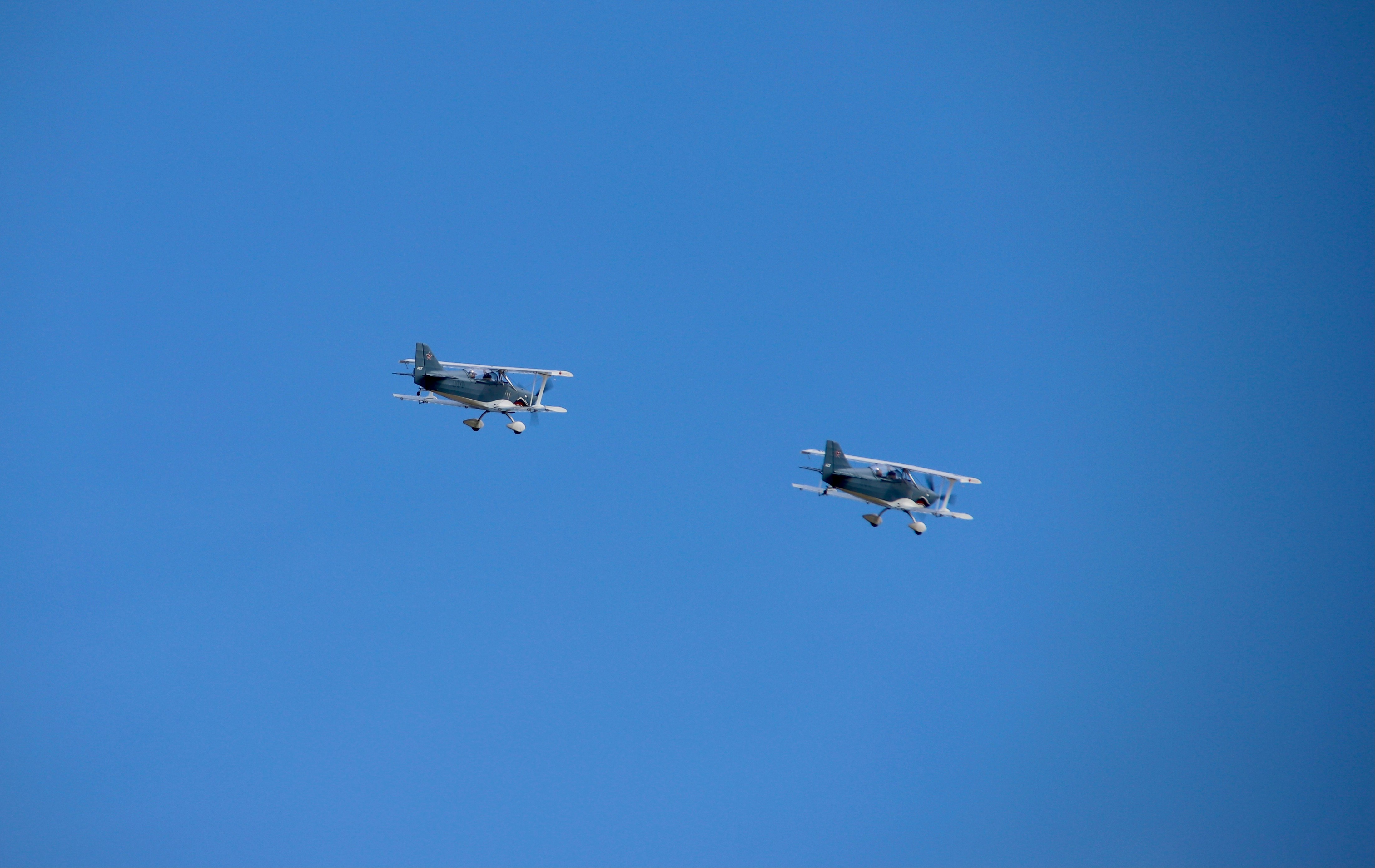 white jet plane in mid air during daytime